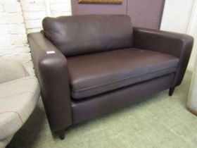 A brown leather effect two seater settee