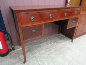 An Edwardian Sheraton revival mahogany desk having two large drawers above two drawers on square