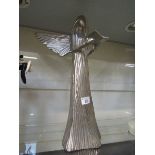 A silvered metalwork figurine of angel holding book