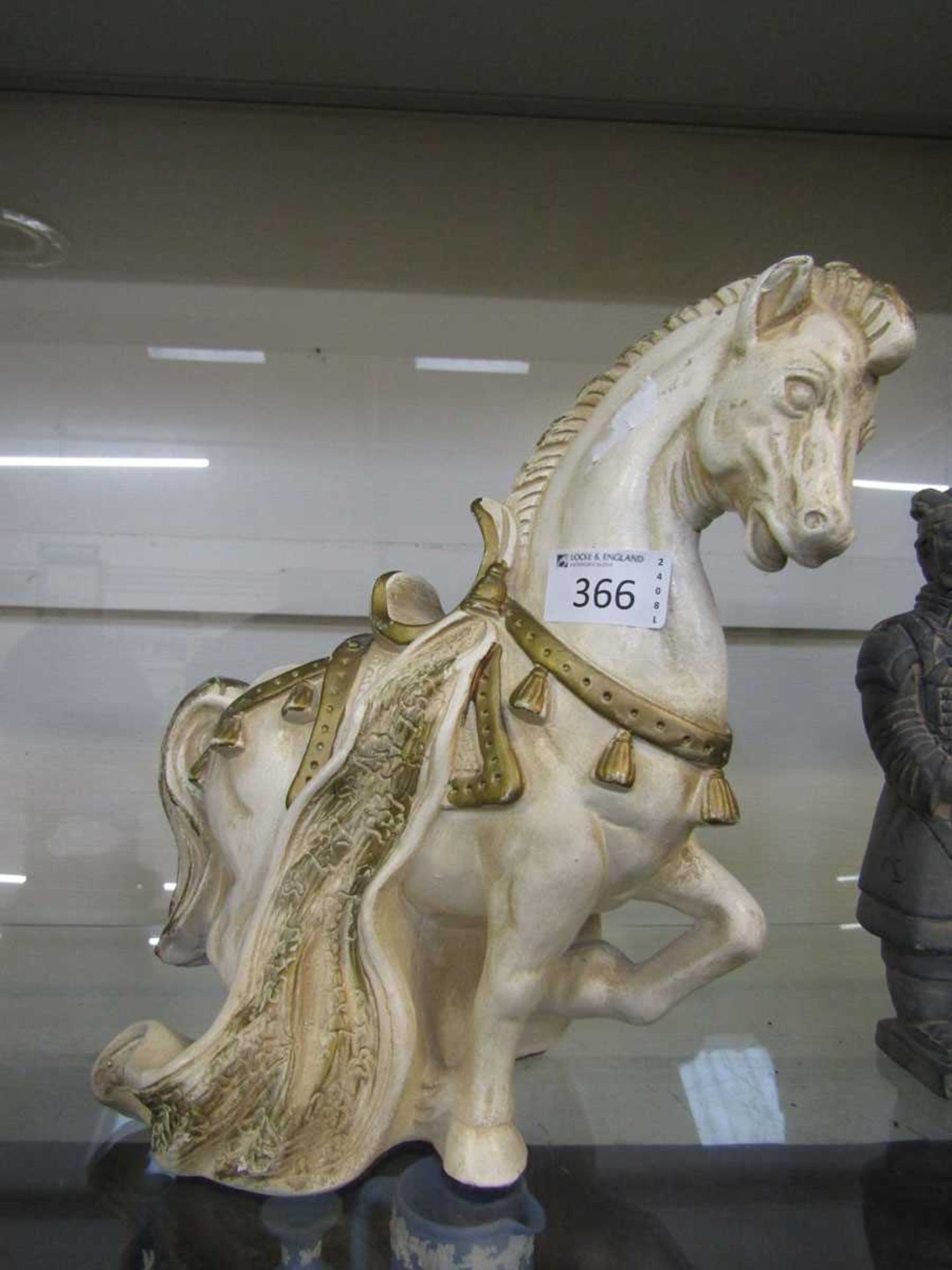 White and gilt painted moulded resin model of a horse