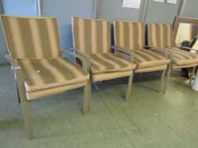 A set of four modern grey metal garden chairs with an assortment of matching cushions