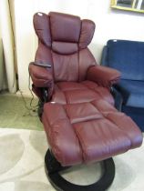 A multi-functional red leather upholstered electric swivel chair with matching footstool