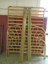 A modern brass effect bedstead Width: 140cm approx. Unfortunately we do not offer post and