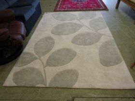 A modern rectangular beige patterned rug