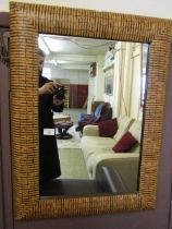 A modern cushion fronted wood effect wall mirror