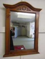 A reproduction cherrywood effect arch topped framed wall mirror