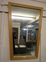 A modern beech effect framed wall mirror