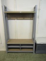 A modern grey and beech effect hall stand with coat hooks and shoe storage
