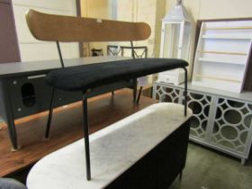 A modern mid-20th century style black velvet upholstered bench with veneered wooden back on chrome