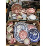 Two trays of pink and blue ceramic tableware to include plates, teapots, etc