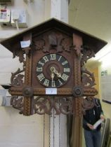 A 20th century Black Forest style cuckoo clock with inlaid parquetry design
