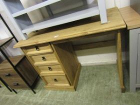 A modern pine desk having four drawers