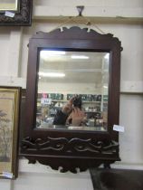 A late 19th century fretwork wall mounted mirror with shelf