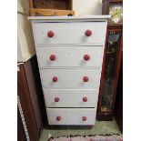 A cream painted pine chest of five large drawers