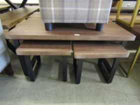 A modern oak effect coffee table on a black metal base incorporating two matching to under