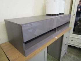 A high glossed hall cabinet with pull up flaps