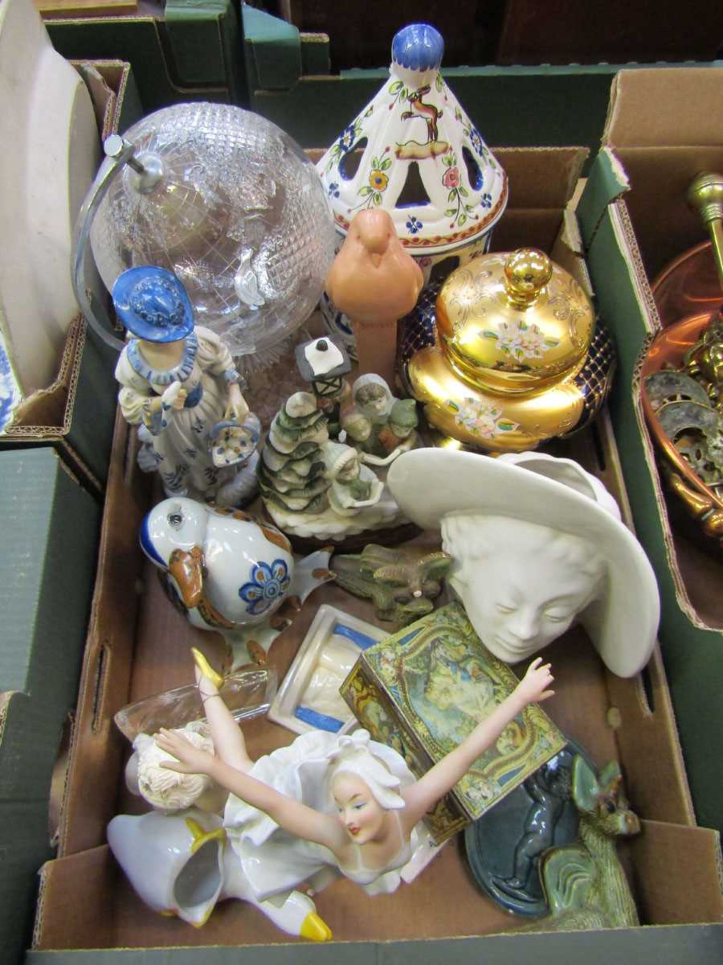 A tray containing decorative ceramic ware to include figurines, cut glass globe, gilt and blue glass