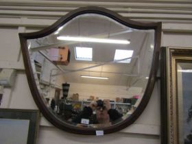 An early 20th century mahogany and strung shield mirror with bevelled glass, 84.5cm wide