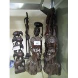 A selection of carved wooden African style items to include busts of lady and gent, tower of