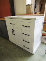 A modern marble topped sill unit having four drawers and a pair of cupboard doors