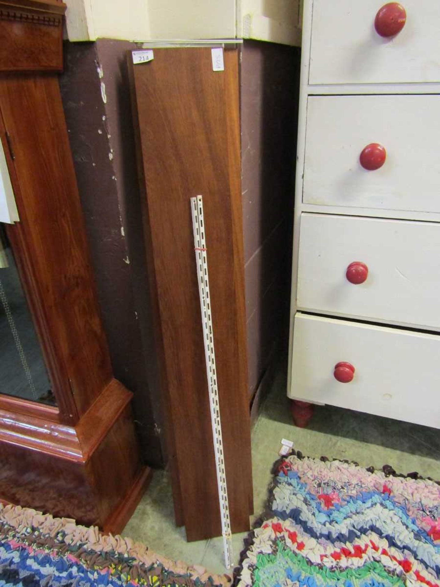 Three mid-20th century teak shelves with white metalwork fixings