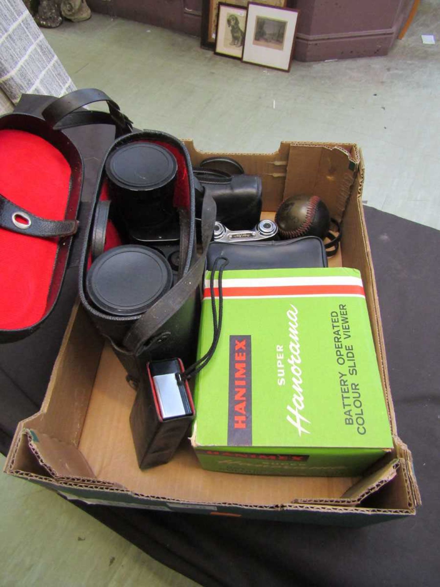 A box containing a pair of binoculars, battery operated coloured slide viewer, opera glasses,
