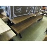 A large oak effect picnic bench along with two matching bench seats