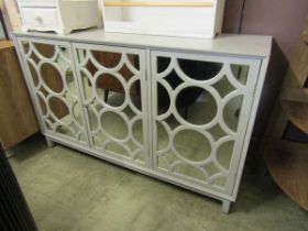 A modern mid-20th century style veneered cabinet with three mirrored cupboard doors