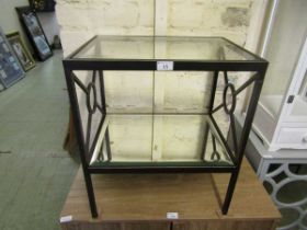 A modern black painted metal framed two tier occasional table, the glass top over the mirrored under