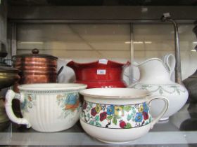 An assortment of three chamber pots and a red glazed ceramic planter