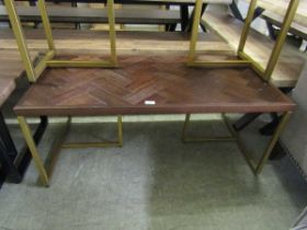 A modern parquet effect topped coffee table on a gold painted base