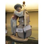 A Lladro ceramic figurine of young boy playing double bass