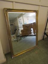 A large ornate gilt framed rectangular bevel glass wall mirror Dimensions: H, 136cm, W, 105cm.