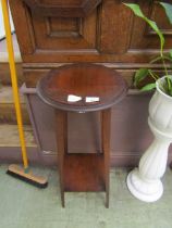 An early 20th century oak two tier jardiniere stand