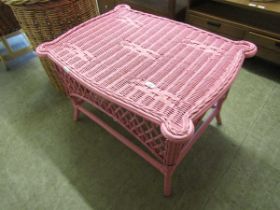 A pink painted wicker occasional table