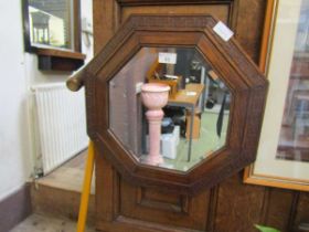 An early 20th century oak framed bevel glass wall mirror