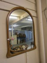 A gold painted arch topped wall mirror