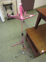 A pink music stand along with a trumpet stand