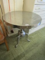 A modern stainless steel circular topped pub table