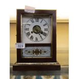 An early 20th century mahogany cased mantel clock with painted glass panel under face