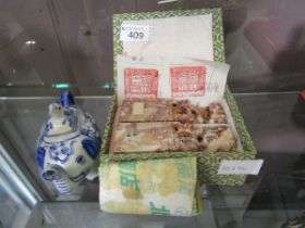 Two reproduction Chinese carved seals together with a blue and white ceramic teapot in the form of