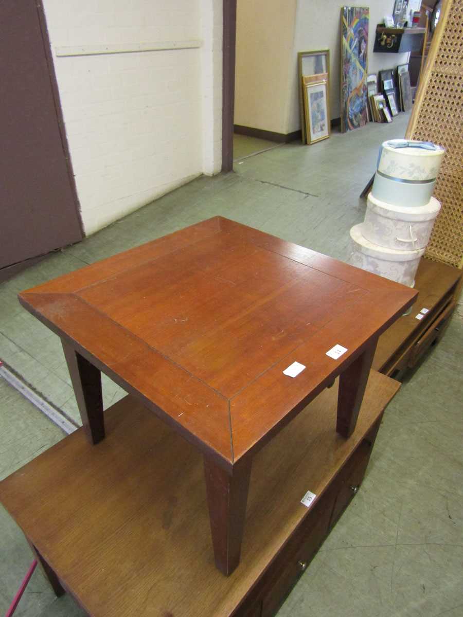 A modern square topped wooden occasional table