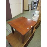 A modern square topped wooden occasional table