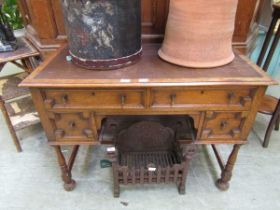 An early 20th century oak desk having two large drawers above two pedestal drawers on turned