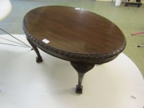 A mid-20th century walnut oval occasional table on ball and claw feet