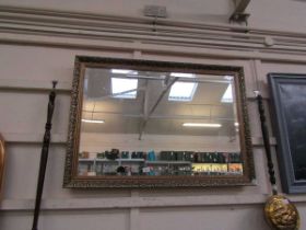 A reproduction ornate gilt framed rectangular bevel glass wall mirror