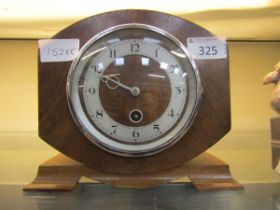 A mid-20th century walnut cased eight-day mantel on bracket feet clock by Newport