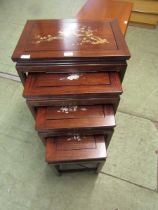 A quartetto nest of Indonesian hardwood occasional tables with mother of pearl inlays to top