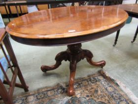 A Victorian walnut oval tilt top tea table