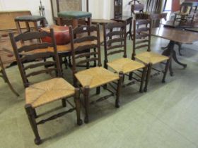 A set of four reproduction oak rail back dining chairs with seagrass seats